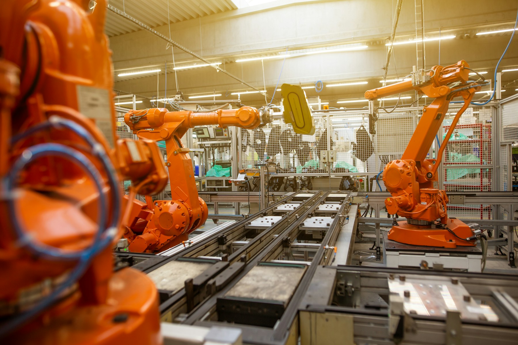 Industrial robot arms and conveyors on an automated factory production line